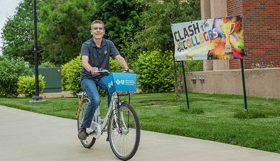 Wichita State student riding his bike on campus
