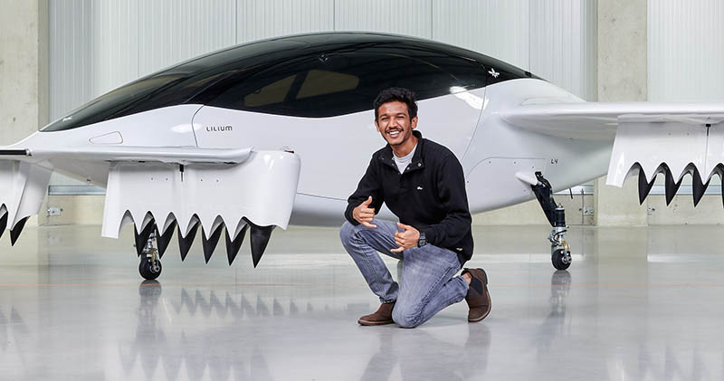 Wichita State Alumni Aadhar Jain poses with a model of the "Flying Taxi," an electric vertical takeoff and landing jet that his employer, Lilium, is developing.