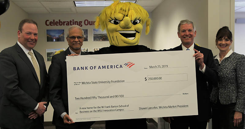 Shawn Lancelot, left, Wichita market president for Bank of America, and John Hesselmann, second from right, a Bank of America executive, presented an oversized check for $250,000 to Elizabeth King, WSU Foundation president and CEO, and Anand Desai, dean of the Barton School of Business, at a special event on March 25.
