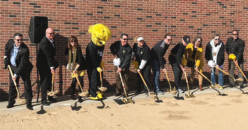 Leaders from WSU Athletics and the WSU Foundation, as well as coaches and donors, plunged shovels into sand to signify the groundbreaking for the Eck Stadium construction project.