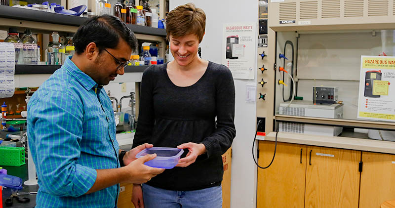 Chemistry Professor Moriah Beck in her lab with Vinay Kadarla, a graduate student pursuing his Ph.D.