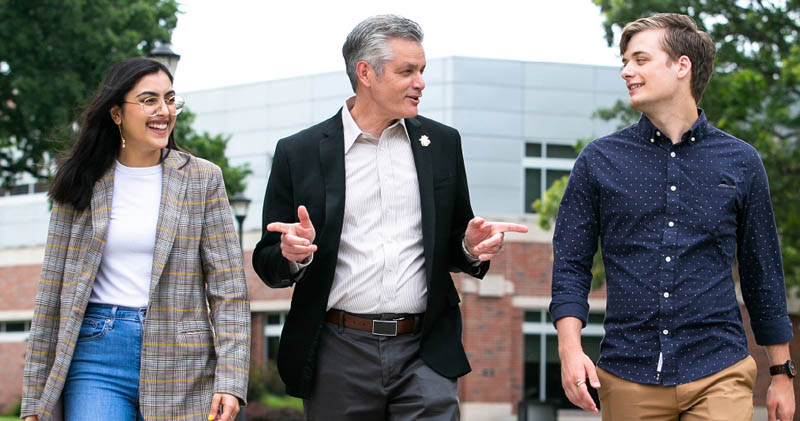 Muma chats with Khan and Tubach during a campus walk.