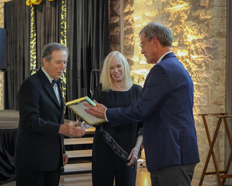 Dan Peare, chair of the WSU Foundation board of directors, presents a certificate to Gus and Mary Campuzano, new Lifetime members of the Fairmount Society.