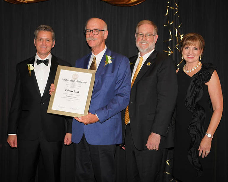 Clay and Clark Bastian, center, represented their family-owned Fidelity Bank in accepting a certificate as new Fairmount Society Lifetime Achievement members.