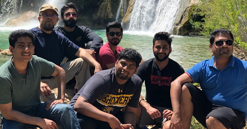 Muhammad Usmani, second from left, helps international students at Wichita State settle into their new home. He’s shown here on a camping trip with students in Oklahoma a few years ago.