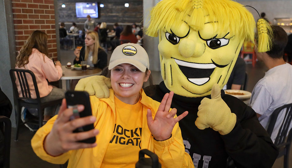 A student poses for a selfie with Wu