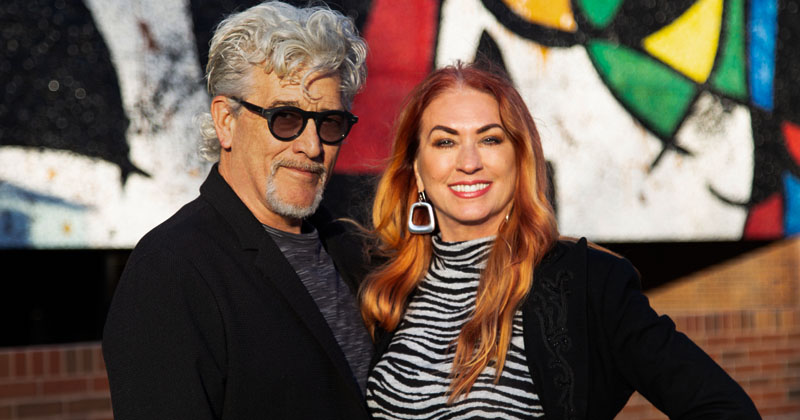 Chris Brunner and Sonia Greteman in front of the Joan Miro mural, “Personnages Oiseaux,” on the facade of the Ulrich Museum of Art.