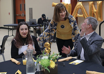 Foundation CEO Elizabeth King greets student emcee, Olga Lesnik, and her scholarship donor, Werner Golling.